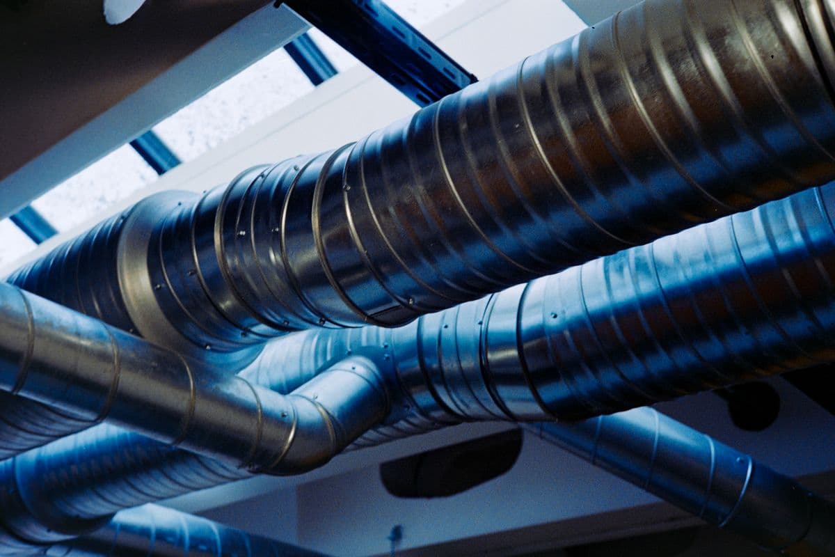 Réseau de ventilation métallique : gaine et raccords d'extraction.