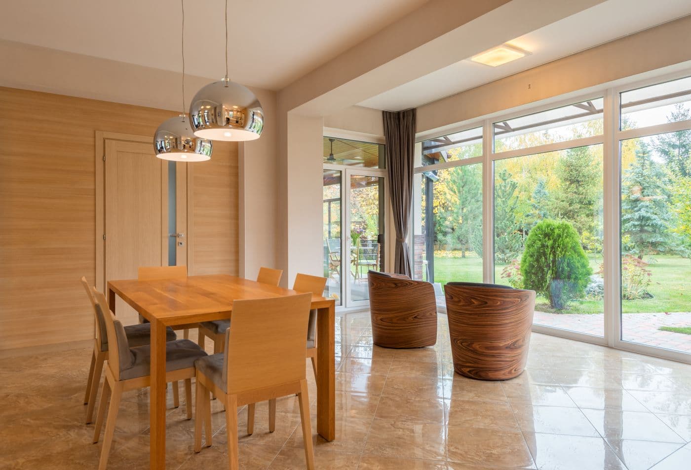 Séjour ouvert sur le jardin par de grandes baies vitrées, parquet et lumière.